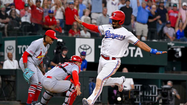 Jun 5, 2023; Arlington, Texas, USA; Texas Rangers second baseman Marcus Semien (2) crosses home plate for the game winning run against the St. Louis Cardinals during the ninth inning at Globe Life Field. Mandatory Credit: Jerome Miron-USA TODAY Sports